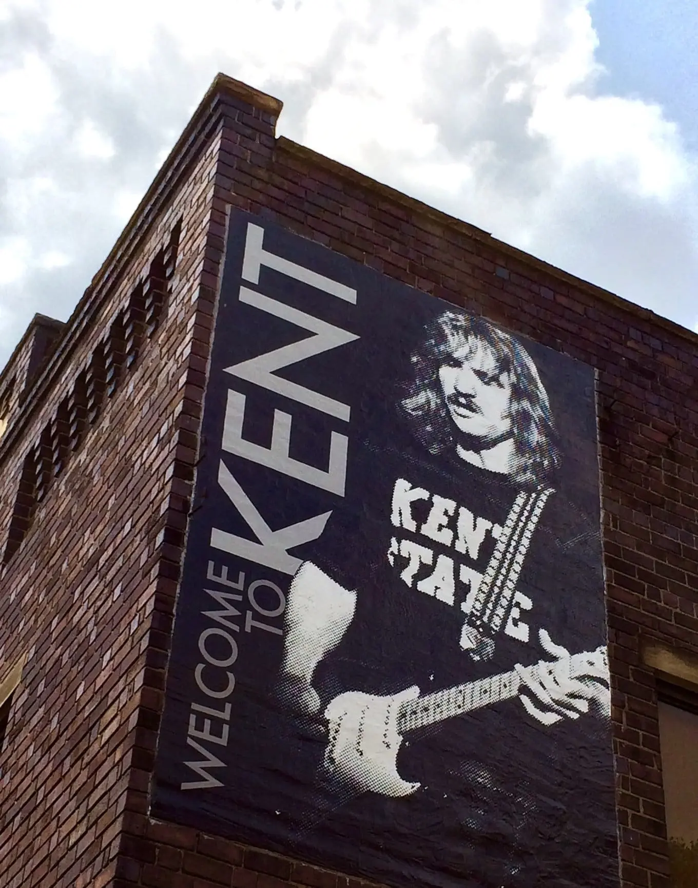 A photo of the Joe Walsh Mural in Kent, Ohio, features Joe Walsh on the side of a building