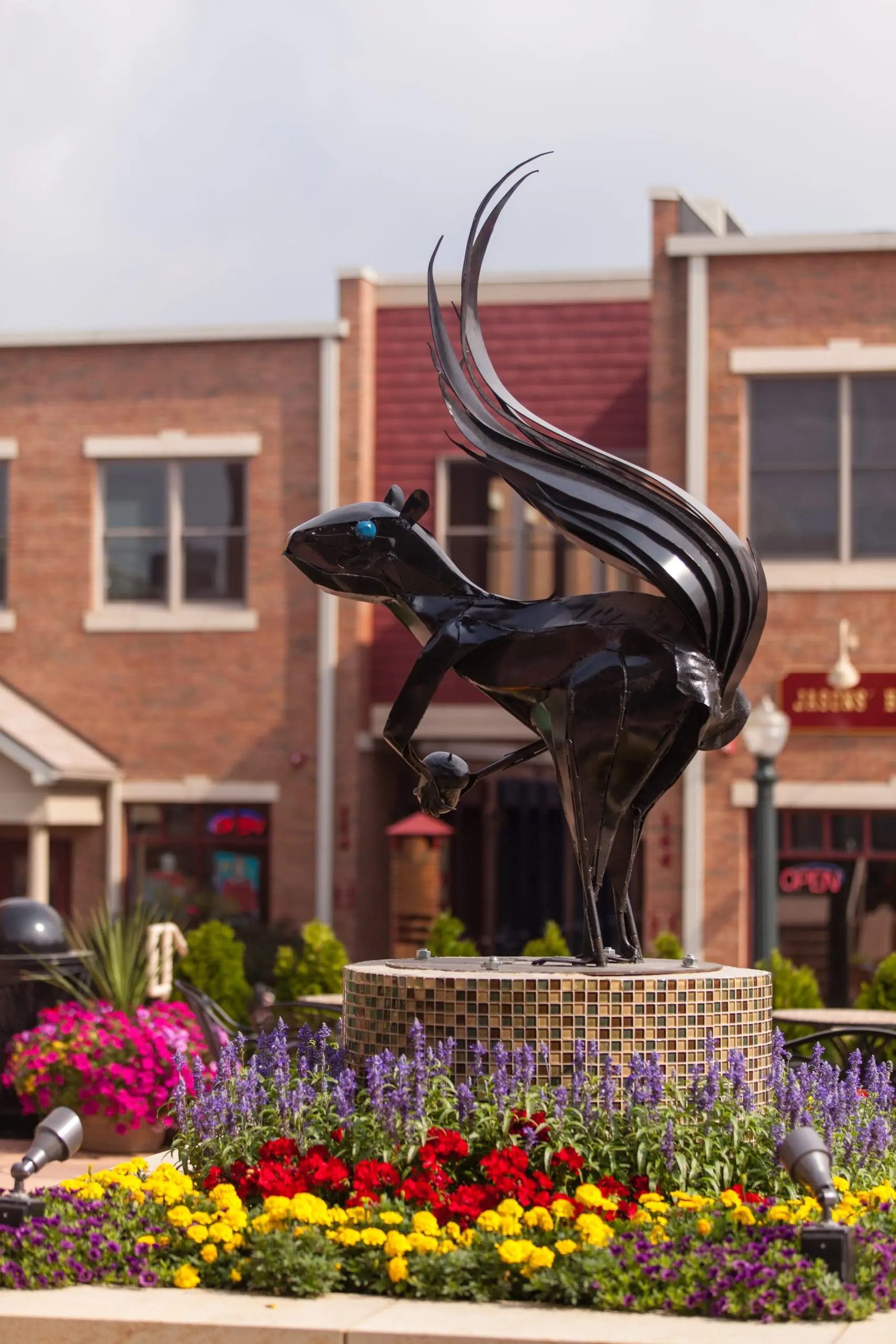 A statue of a squirrel holding an acorn in Acorn Alley in Kent Ohio